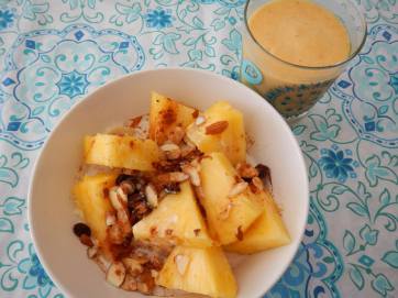 quinoa cinnamon almond breakfast bowl with tropical fruit medley and coconut milk and banana pineapple mango smoothie